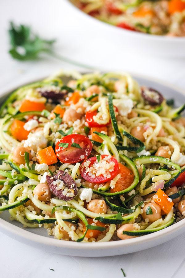 Close-up shot of a vibrant Mediterranean Quinoa Salad with Zucchini Noodles.