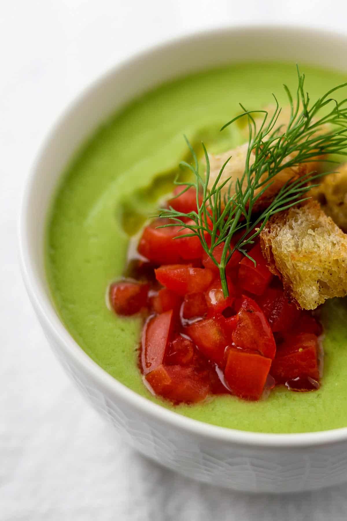 Close-up shot of a bowl of chilled cucumber soup with fresh dill