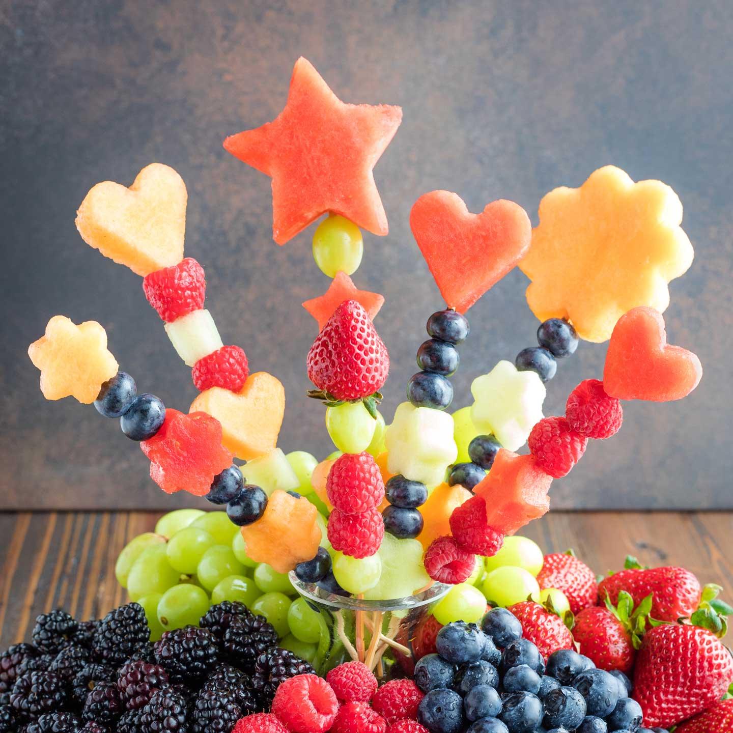 Star fruit kebabs arranged on a plate with other fruits