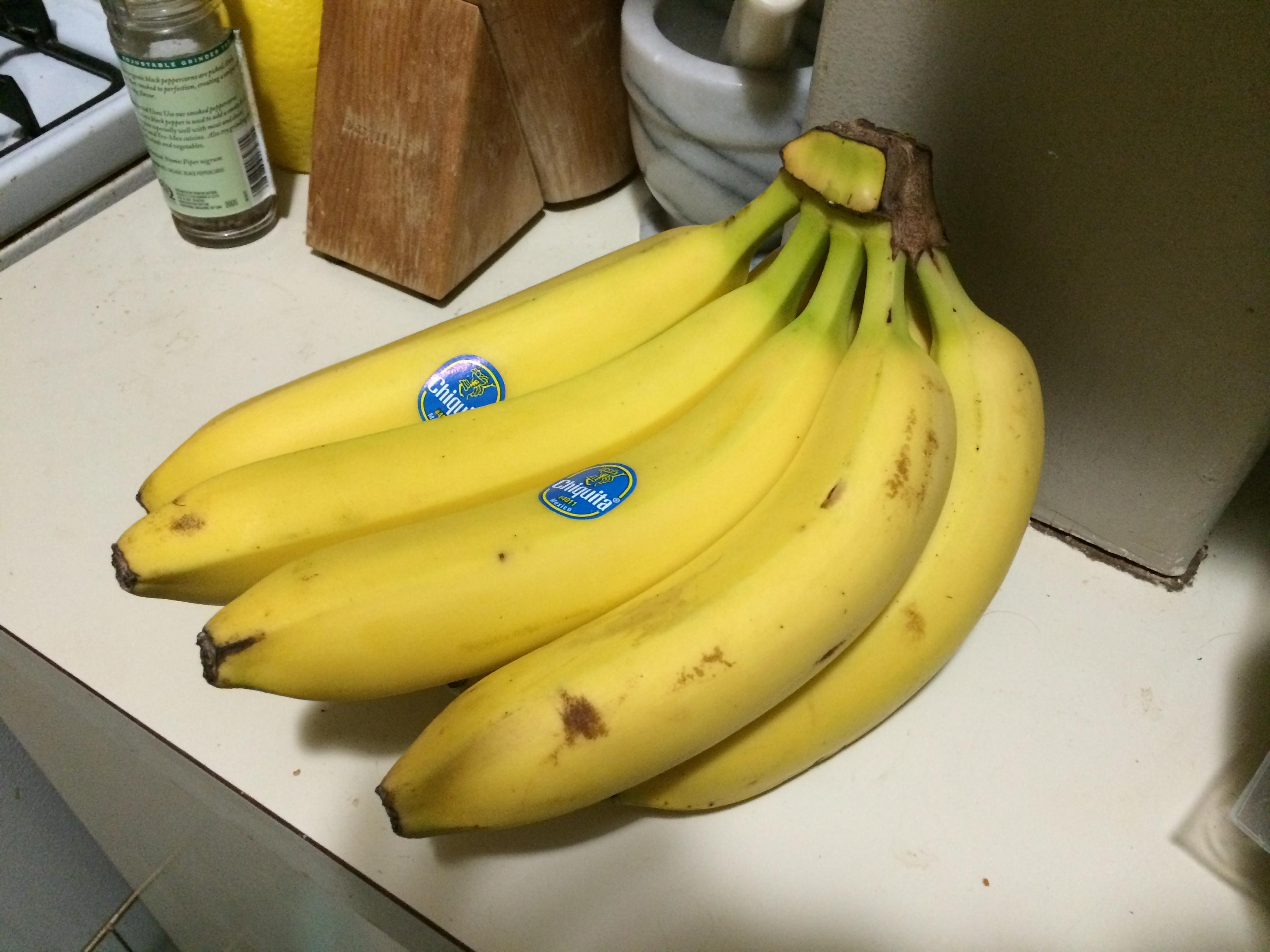 Pile of very ripe, spotty bananas on a kitchen counter