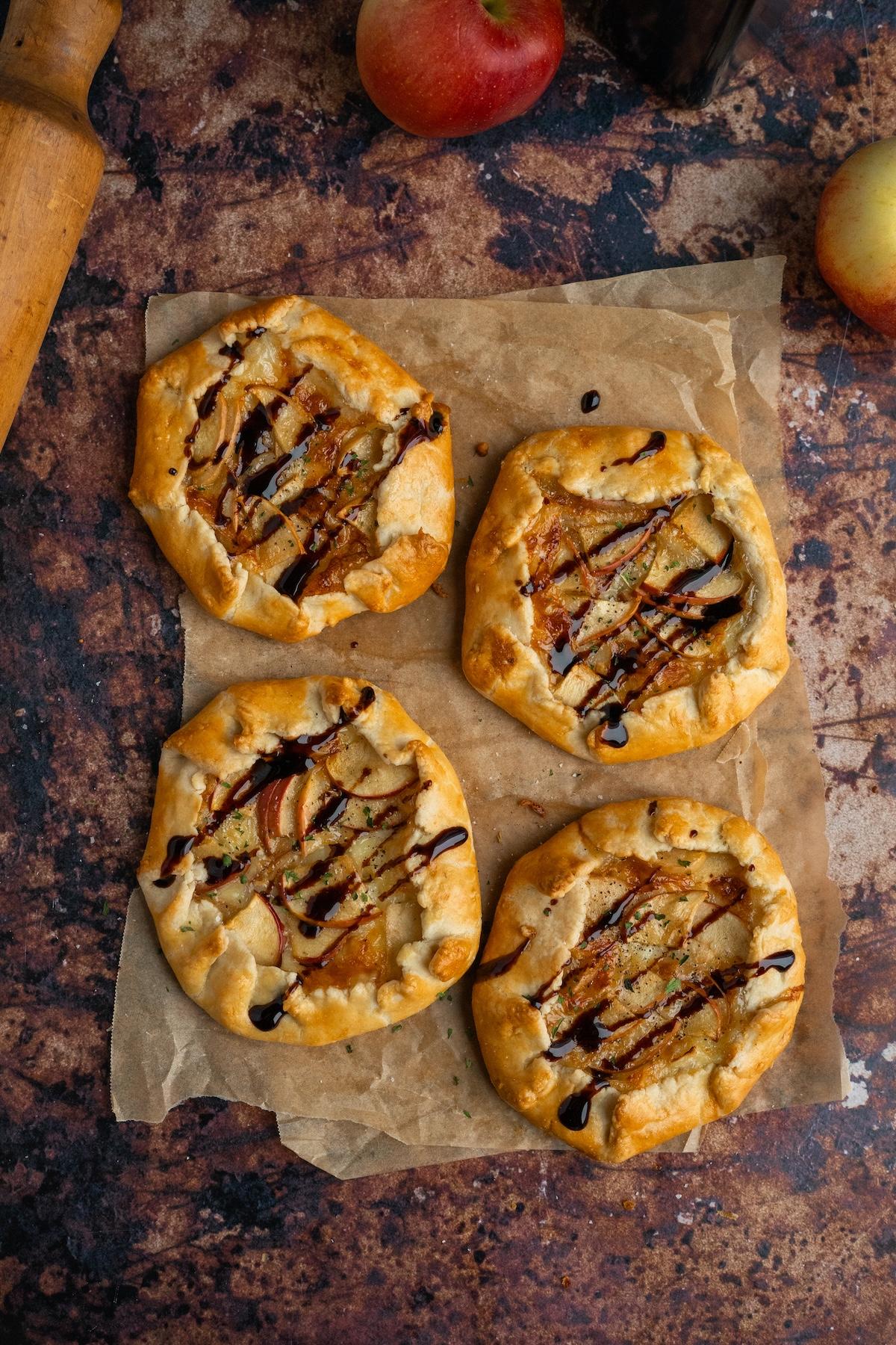 aerial view of a whole apple pumpkin brie galette on a parchment-lined baking sheet