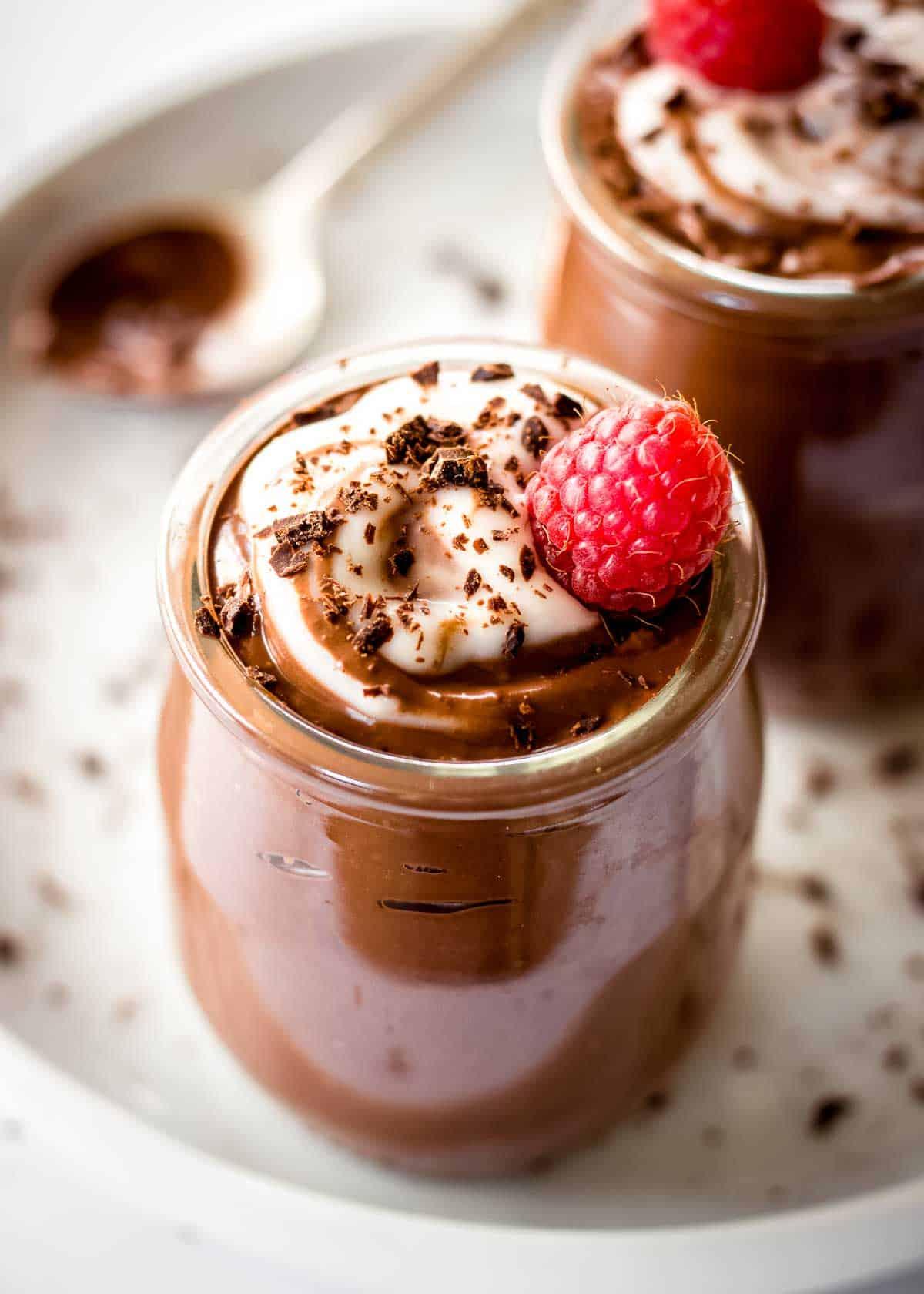 various servings of chocolate avocado mousse decorated in different ways