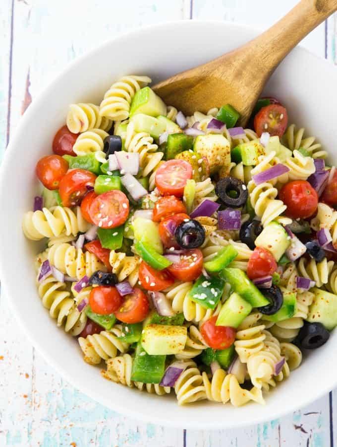 bright and colorful California pasta salad with avocado and sprouts