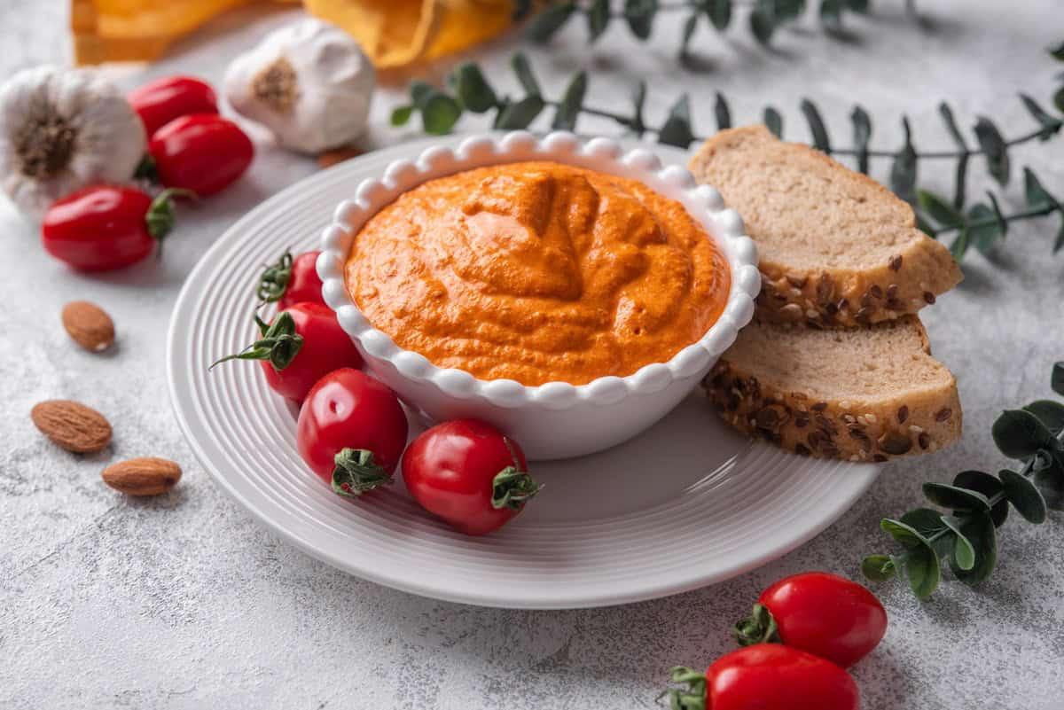 A bowl of roasted red peppers, ready to be processed into dip