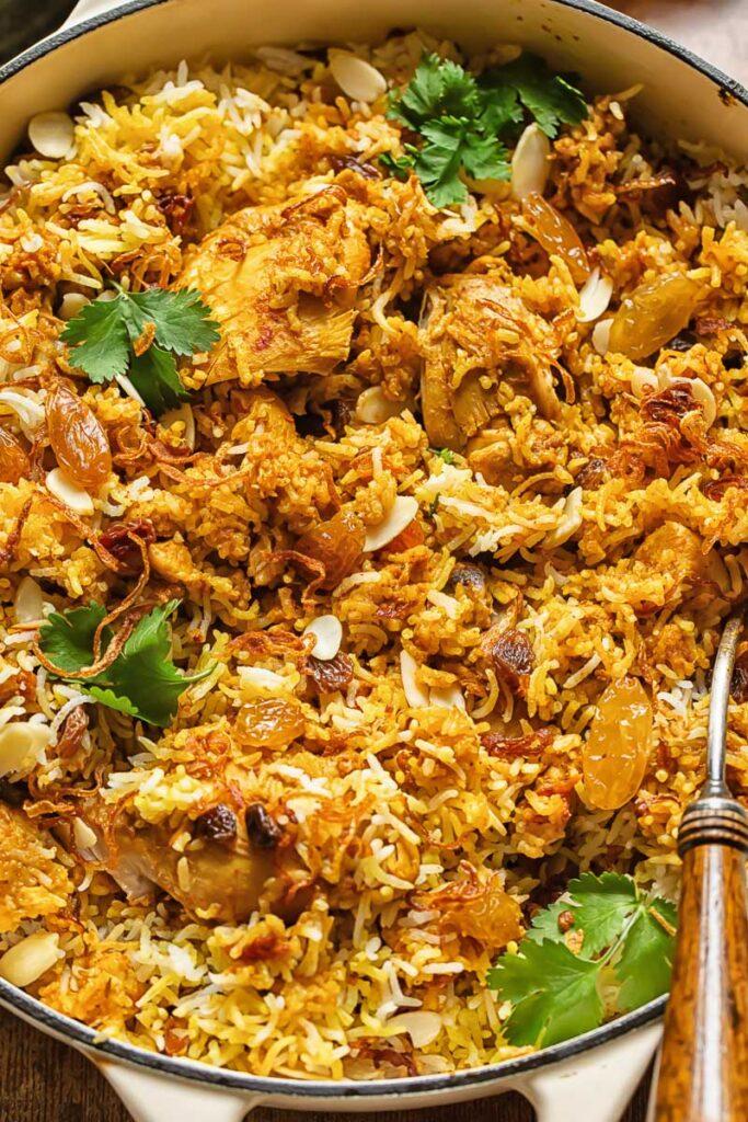 ingredients for almond biryani arranged on a wooden table