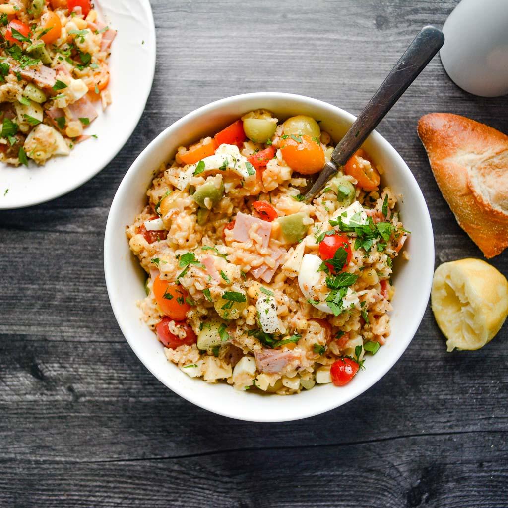 close-up of jollof rice salad with lemon vinaigrette drizzled over it