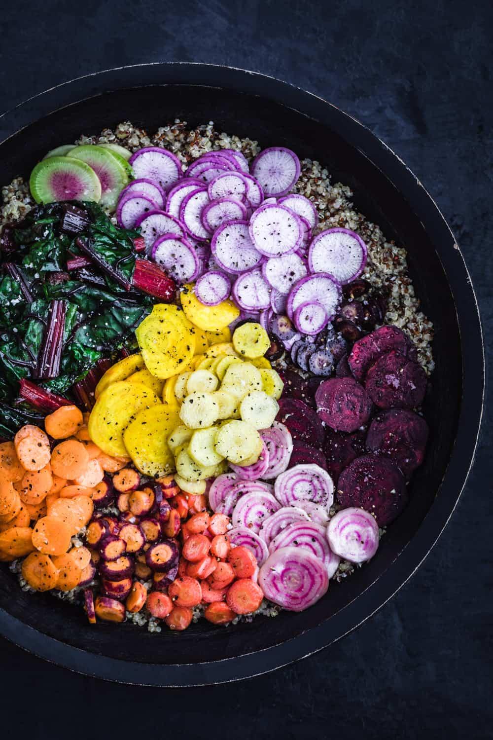 vibrant rainbow veggie and quinoa rice bowl with various colorful vegetables