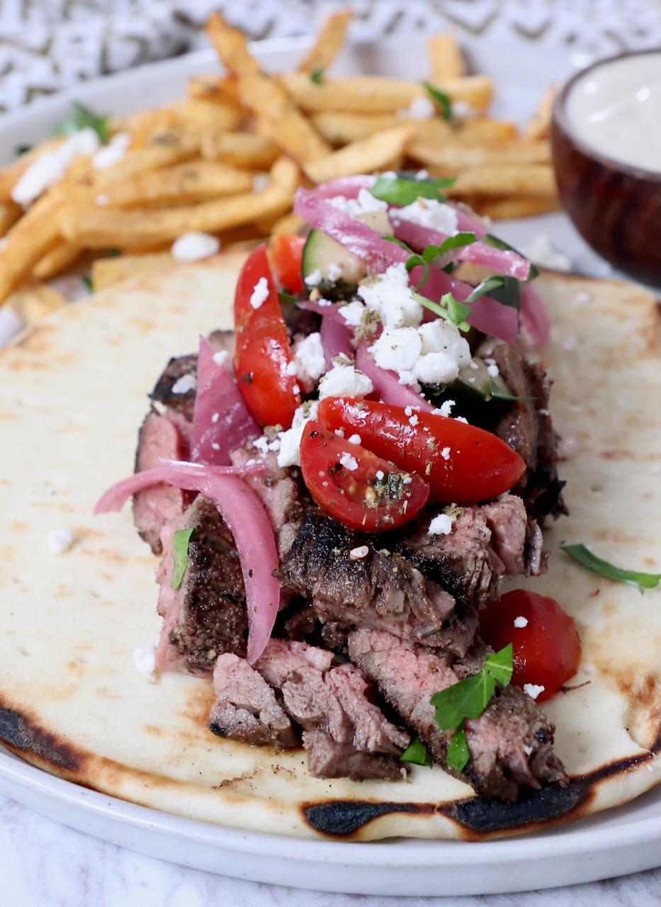 honey chipotle beef shawarma plated with pita bread and toppings