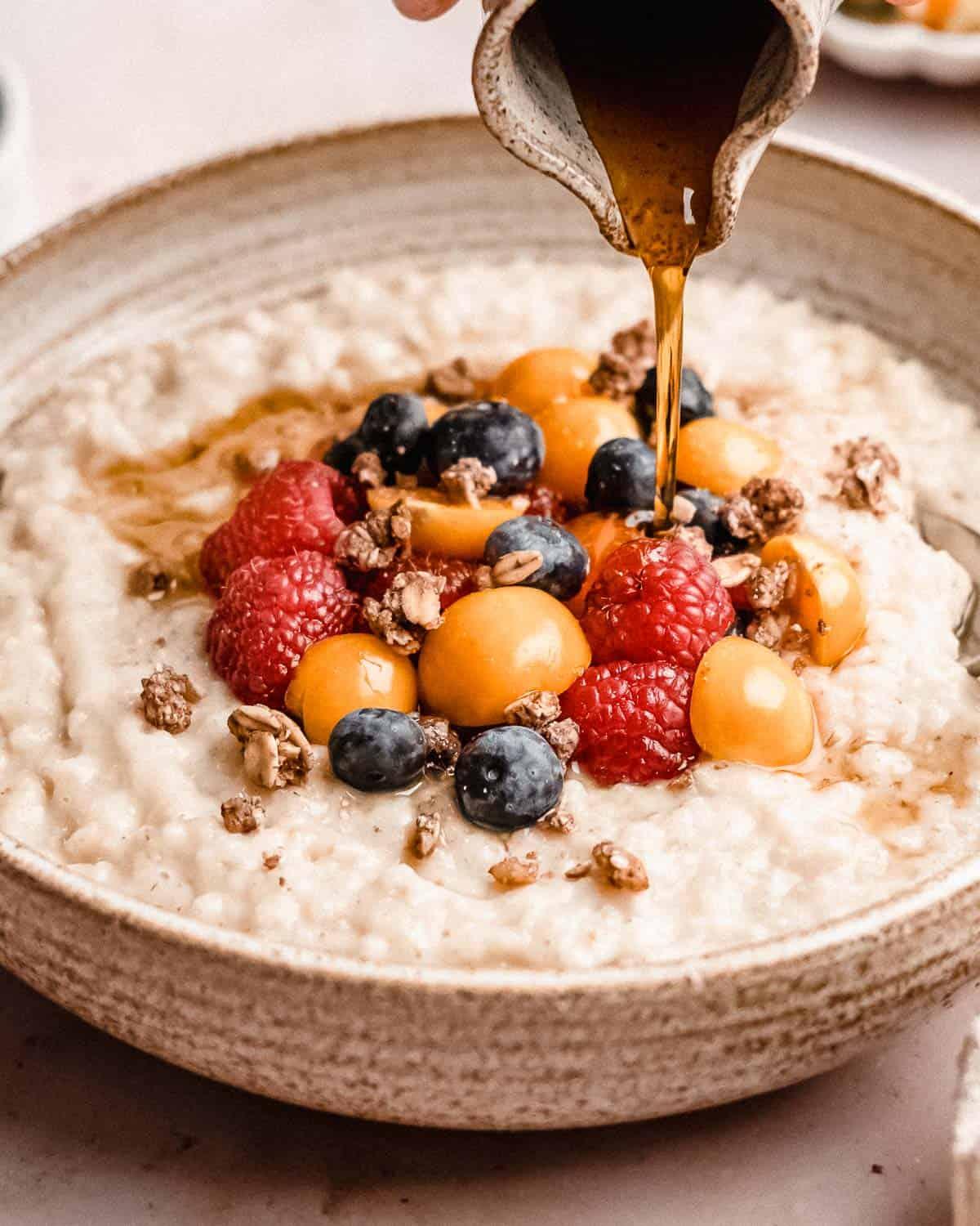 close-up of creamy barley porridge with honey drizzle and cinnamon sprinkle