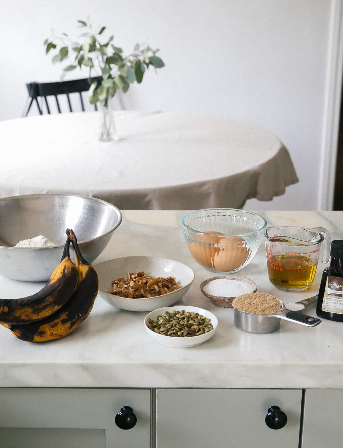 Overripe bananas on a kitchen counter next to a mixing bowl