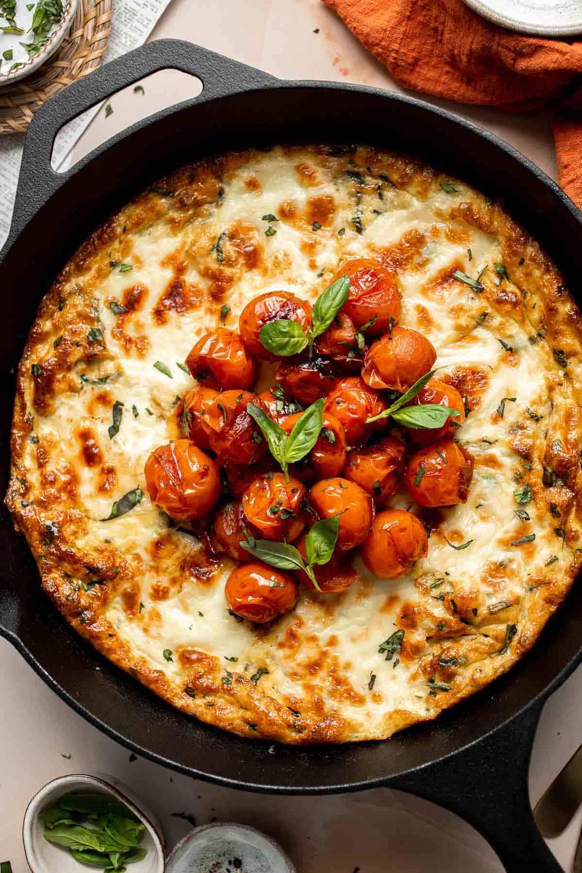 a perfectly cooked cherry tomato and burrata frittata with a golden crust