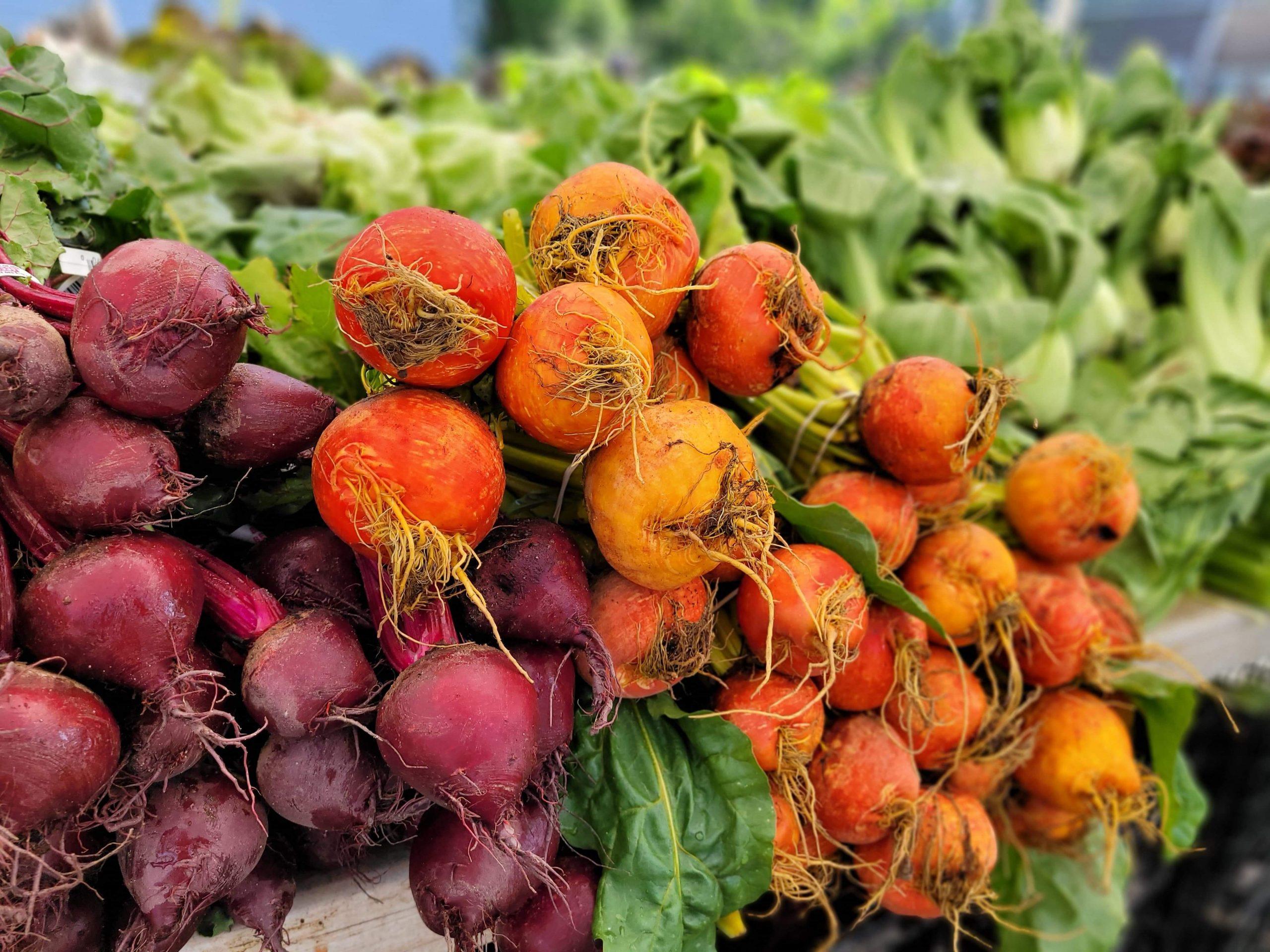 fresh beetroot and spinach at a farmers market