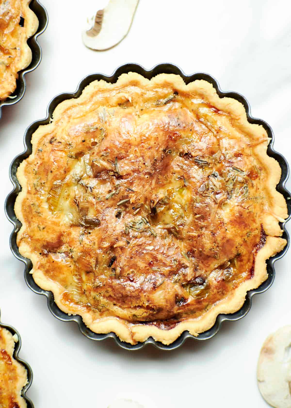 Close-up shot of a slice of Leek and Gruyere Quiche showing the layers