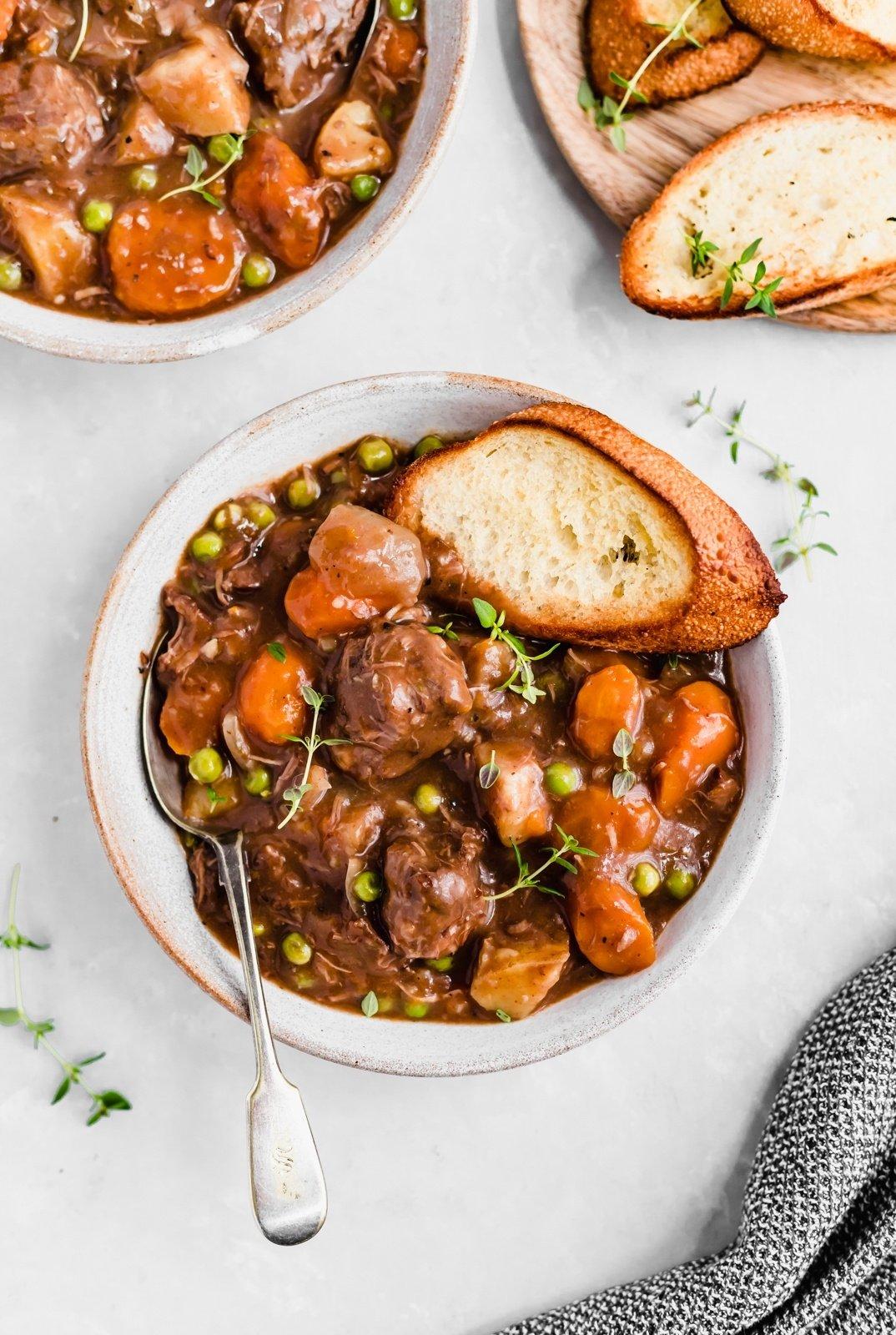 Slow cooker beef stew with vegetables and crusty bread