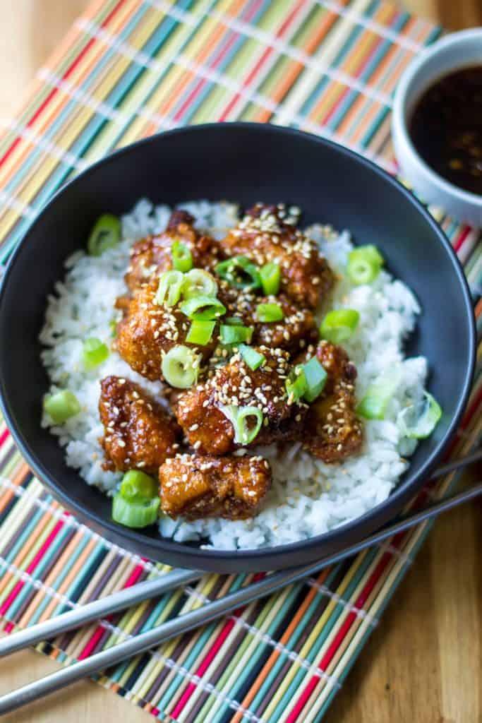 sticky chicken rice bowl being assembled
