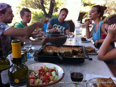 A family enjoying a meal of one-pan moussaka
