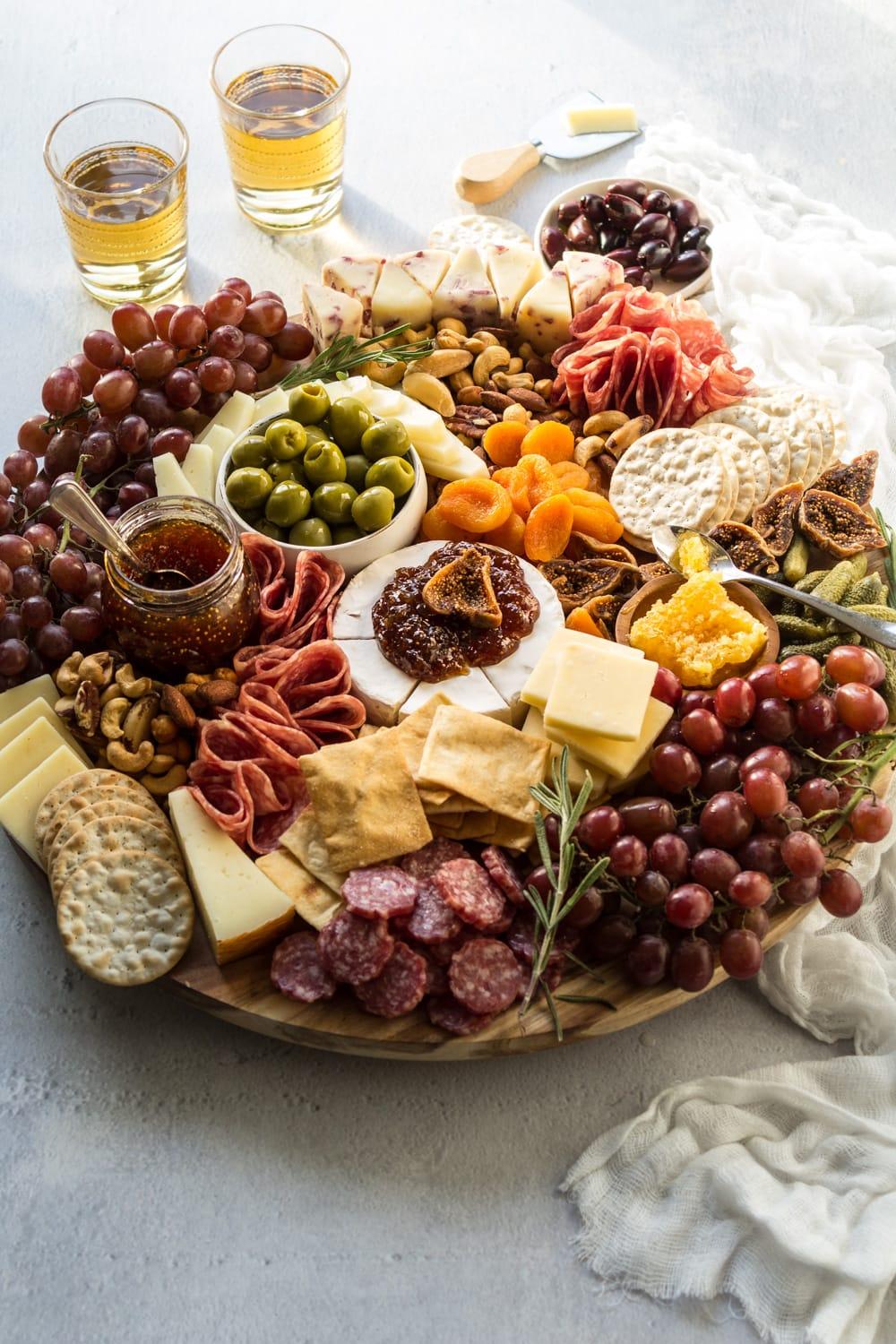 Close-up shot of savory keto cheese and olive crackers on a wooden board