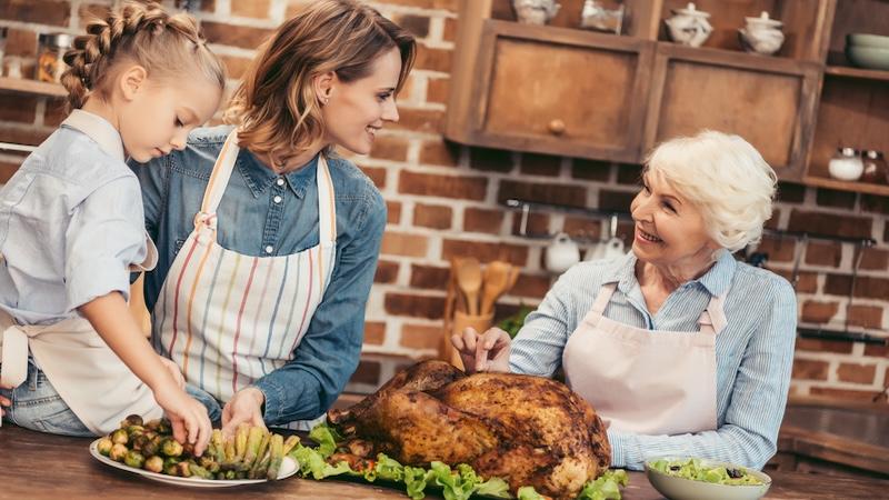 kitchen scene with roasted turkey and happy family
