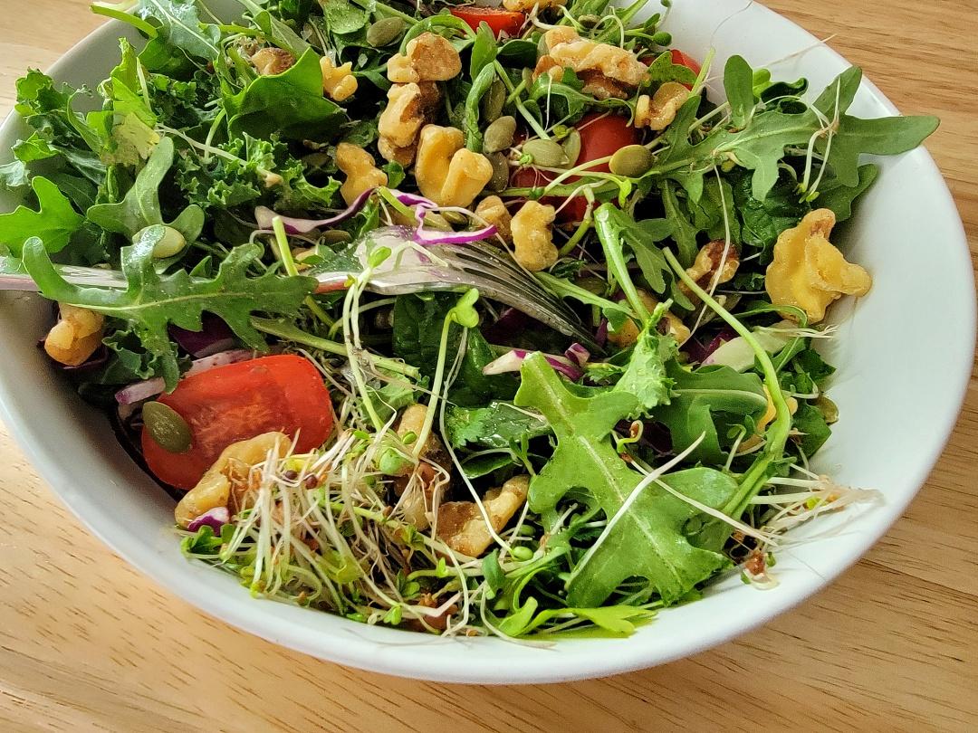 bowl of salad with nuts and seeds