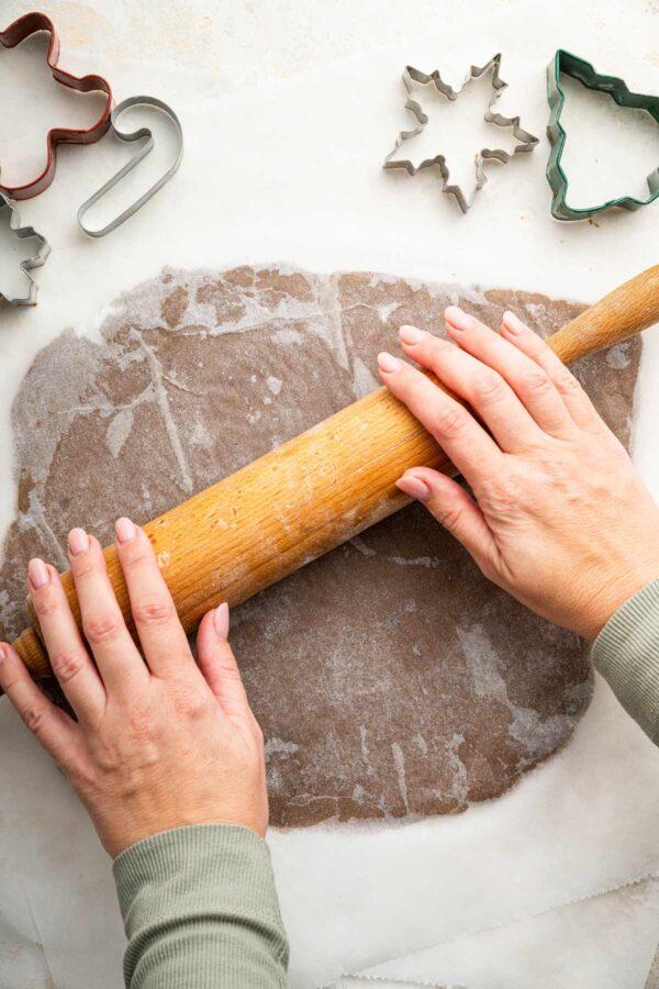 close up of soft gingerbread dough being rolled out on a floured surface