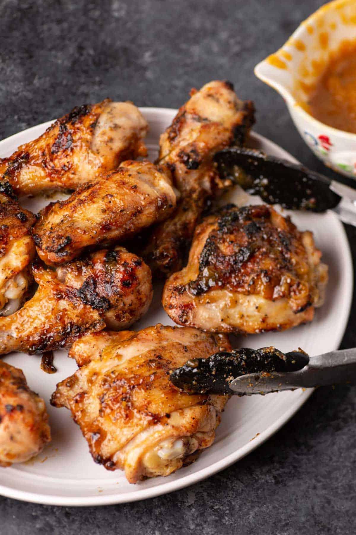 close-up of grilled chicken drumsticks with peach glaze