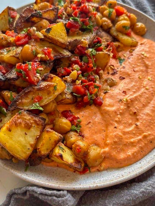 Close up of the ingredients for boiled potatoes with roasted red peppers and feta