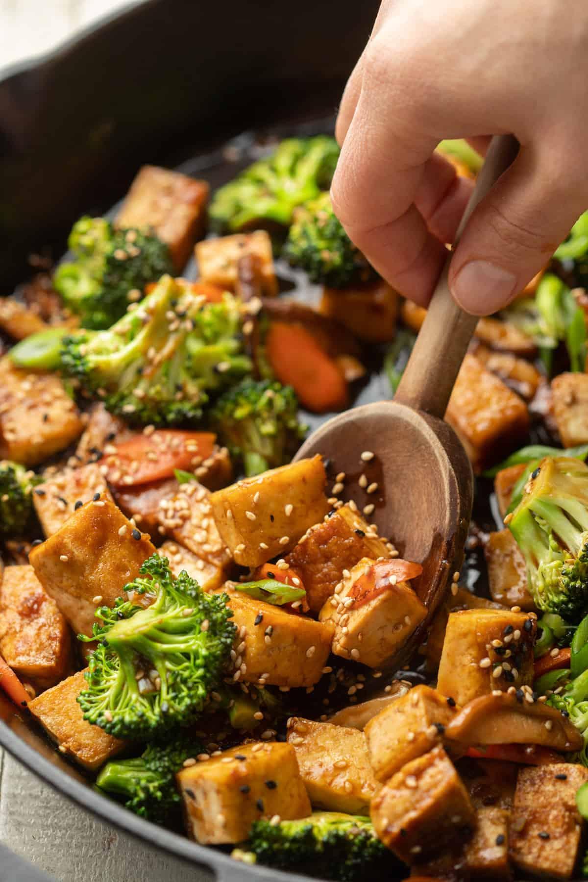 close-up shot of tofu being stir-fried in a wok
