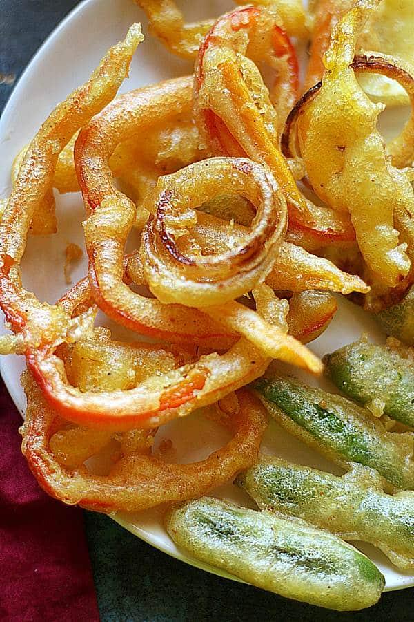 Close-up shot of freshly fried kimchi and vegetable tempura showing the crispy texture