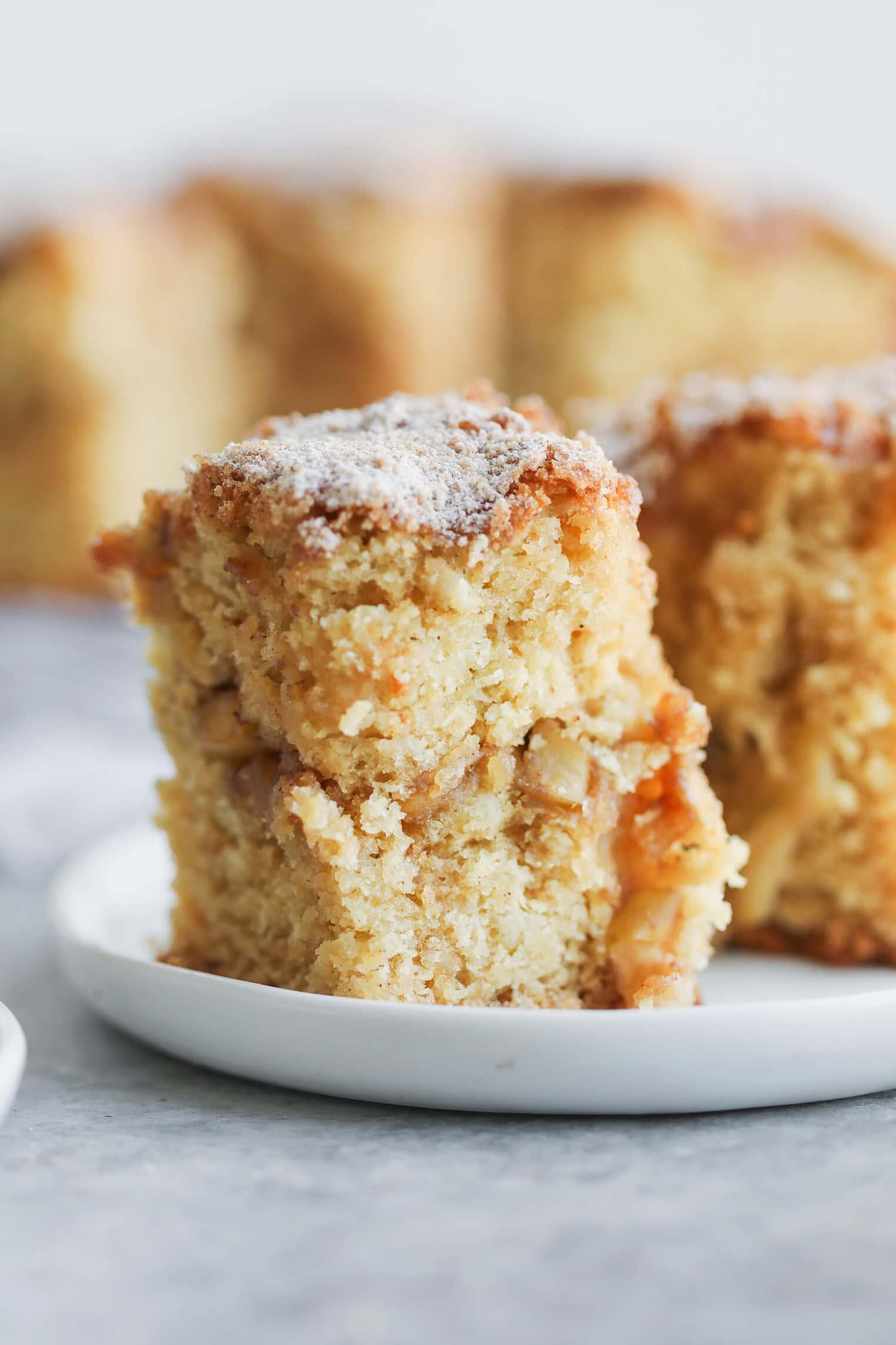 close-up of a slice of cinnamon apple cake with visible apple pieces