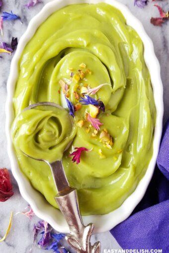 Close-up of avocado mousse being spooned into a glass