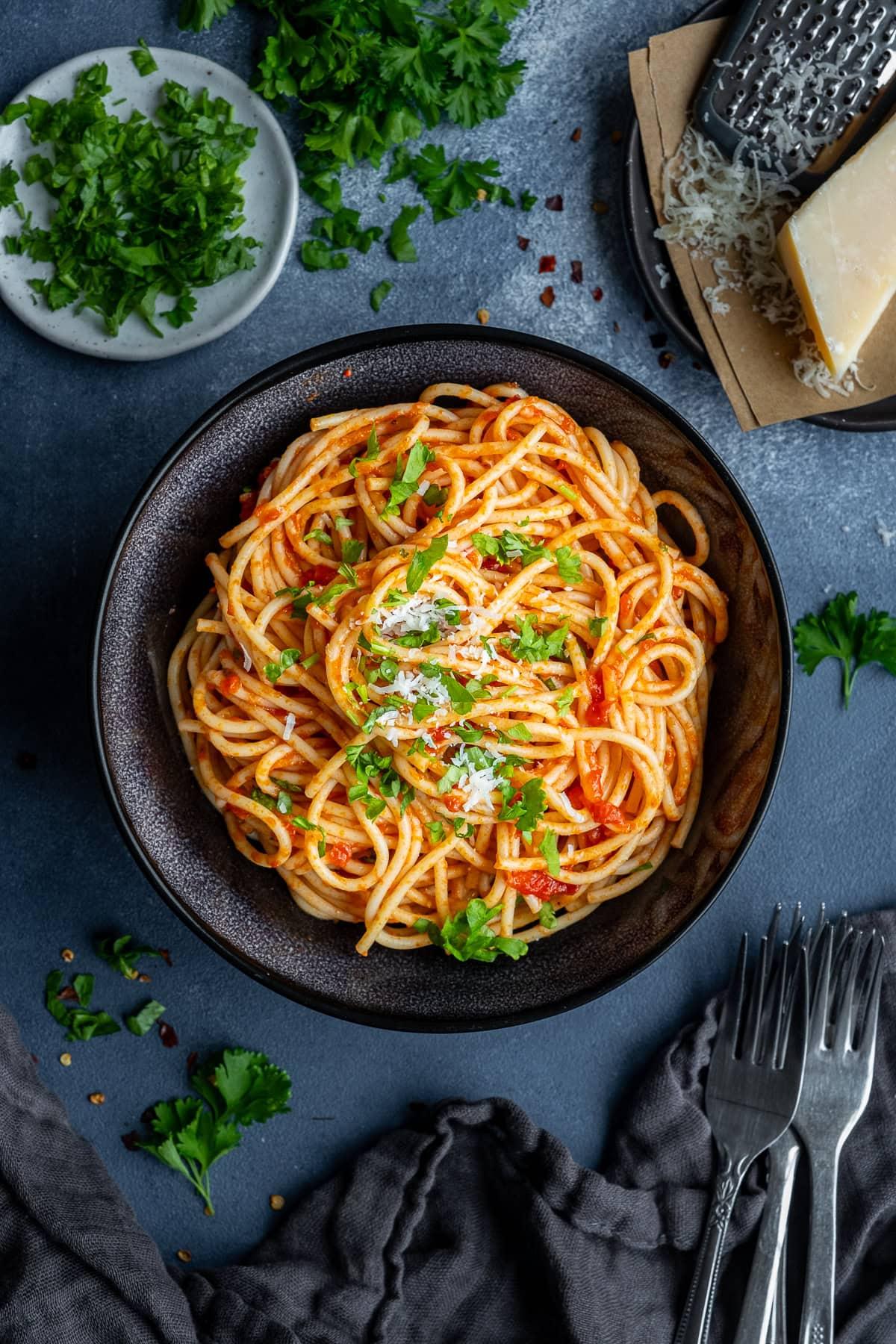 Overhead shot of Arrabbiata Ramen in a bowl, garnished with basil