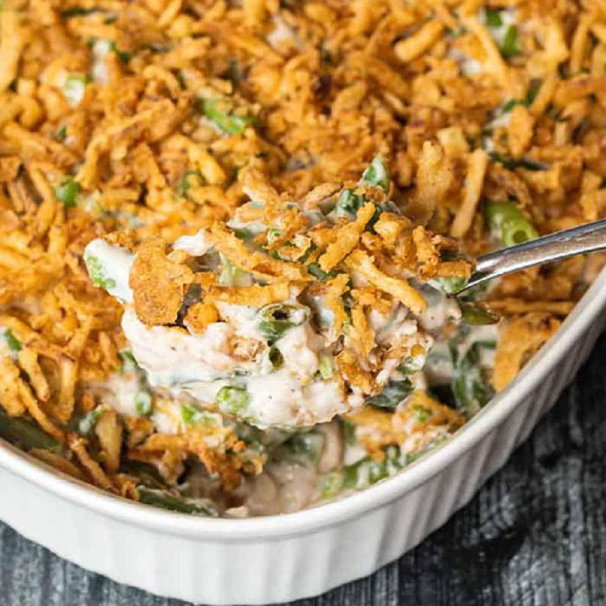 creamy green bean casserole with golden fried onions, close up
