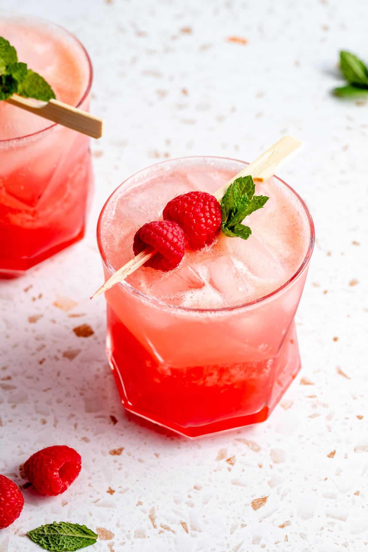 Person making a raspberry mocktail