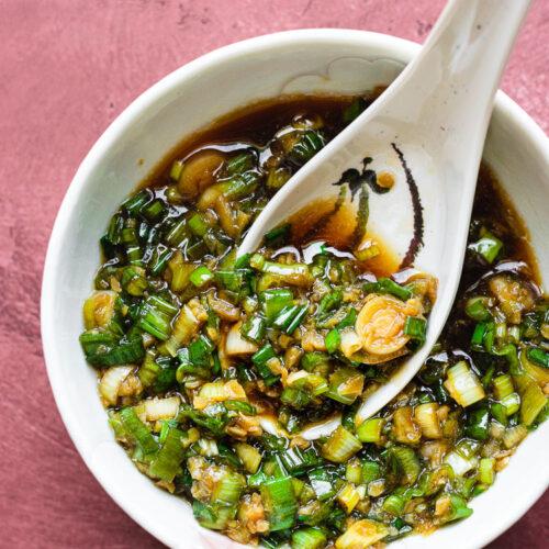 Asian dip with sesame crackers and green onions