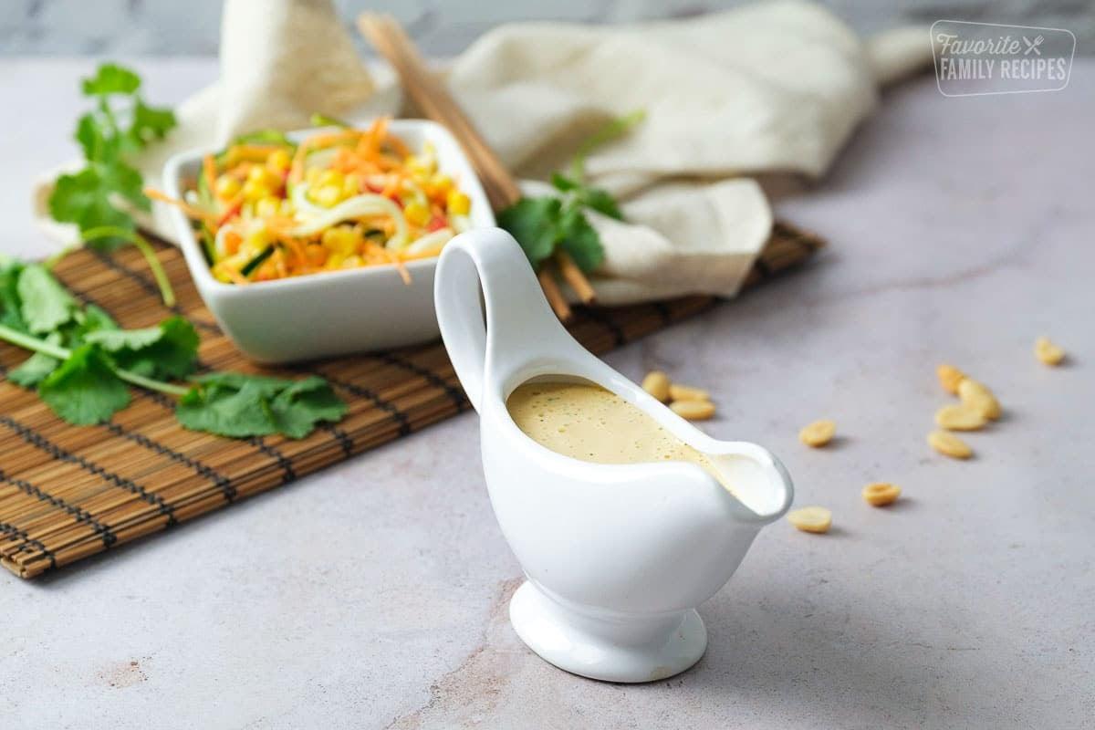 close-up shot of a spoon scooping up the salad with the creamy peanut dressing