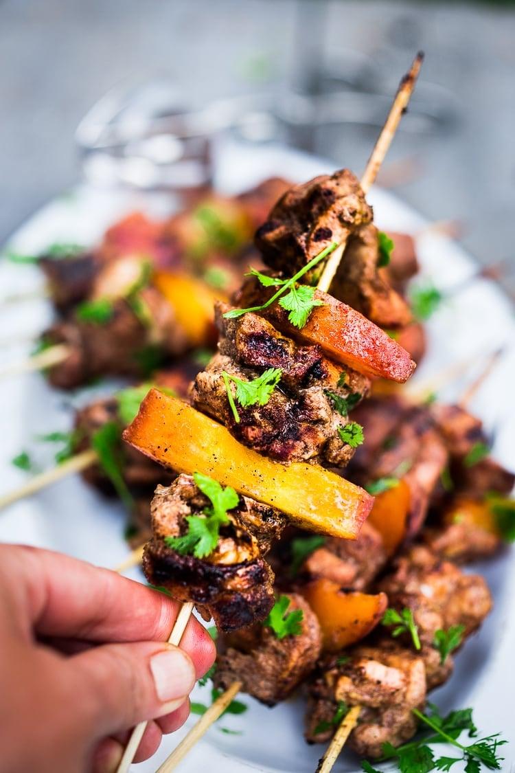 colorful cocktail with jerk chicken skewer garnish