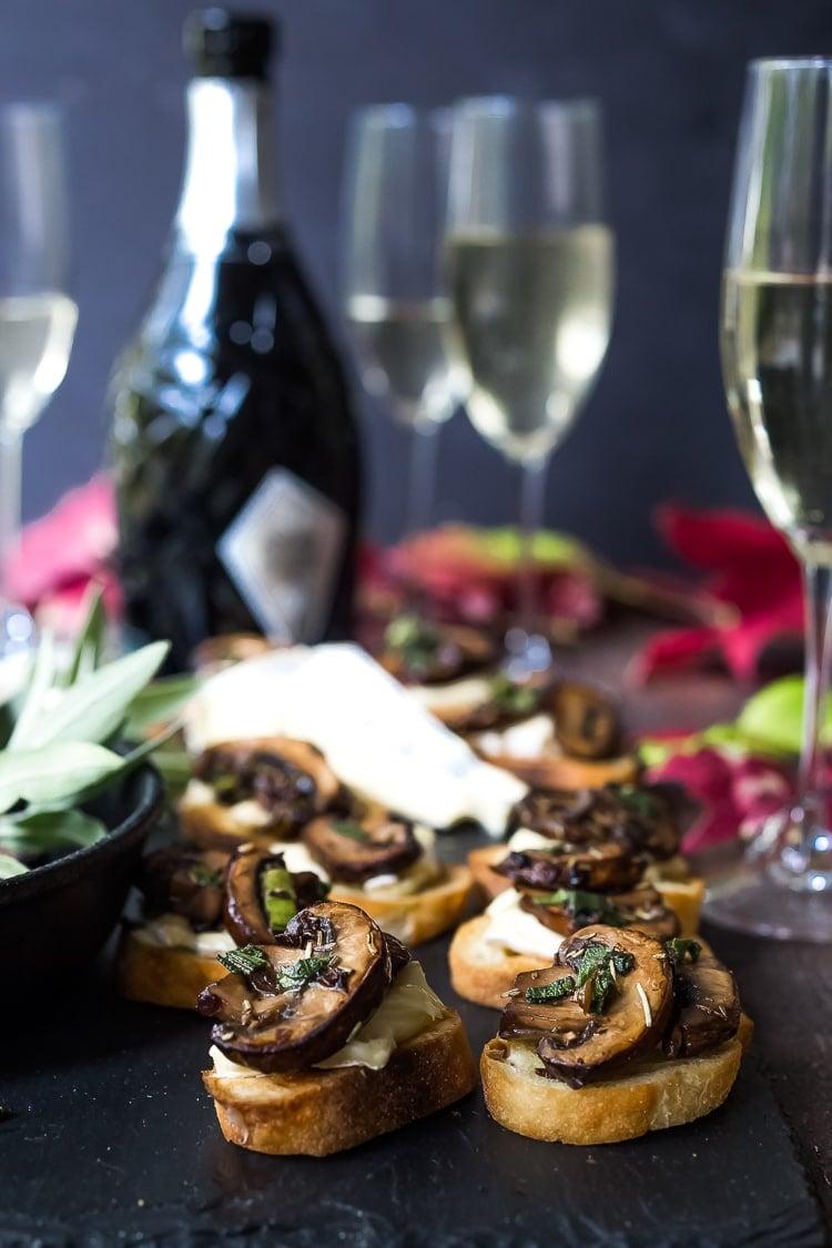 a platter of mushroom truffle parmesan cookies served with a selection of cheeses and wine