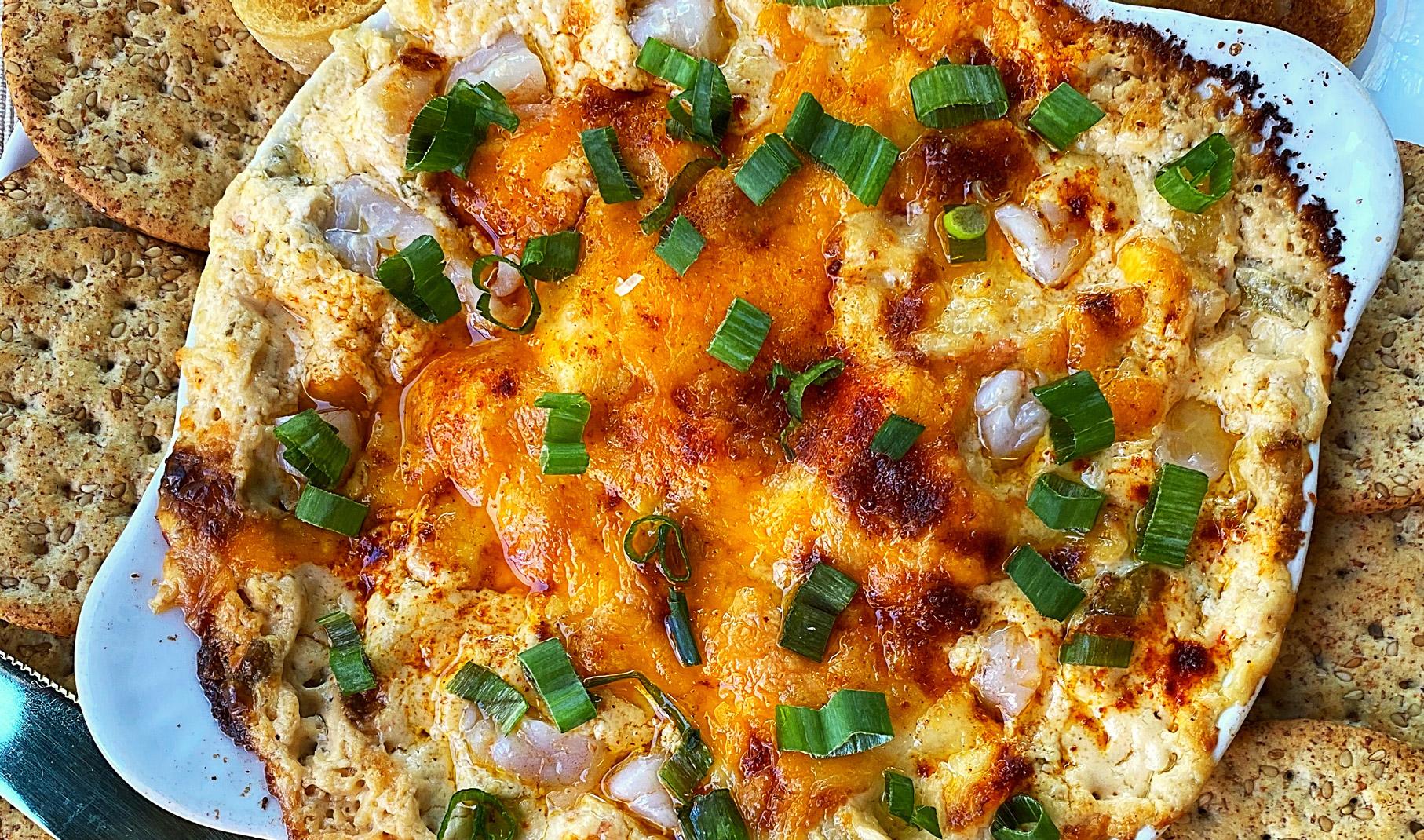 close-up of a bubbling baked crab dip being pulled from the oven, steam rising from the dish