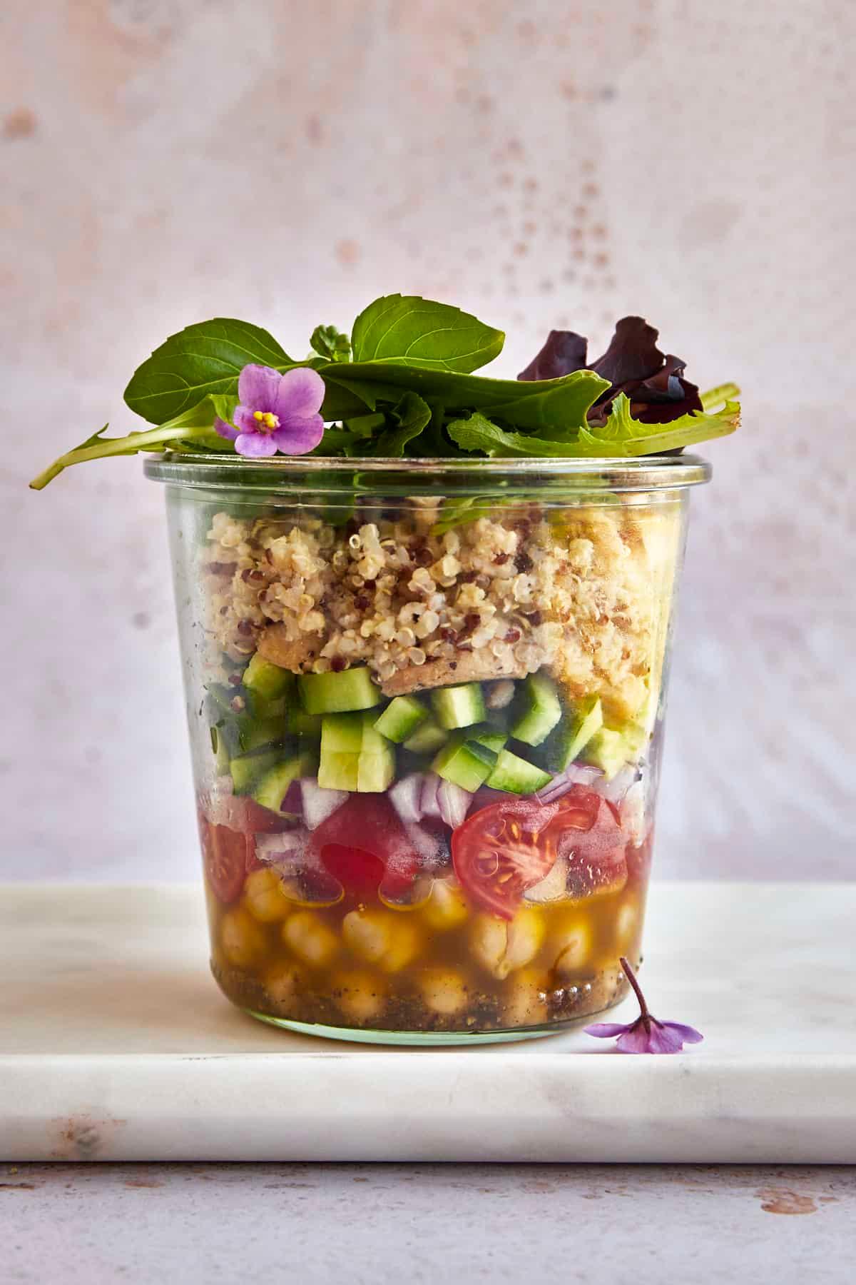 Mediterranean quinoa pasta salad served in mason jars for a picnic