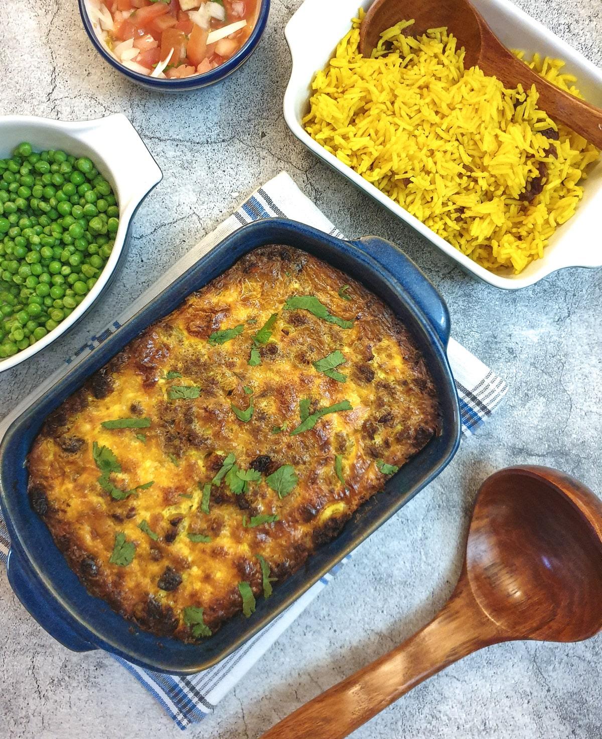Overhead shot of Bobotie in a baking dish, ready to be served