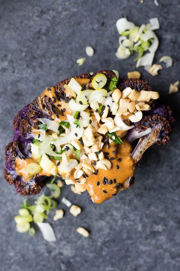 close-up shot of peanut sauce being poured over cauliflower steak
