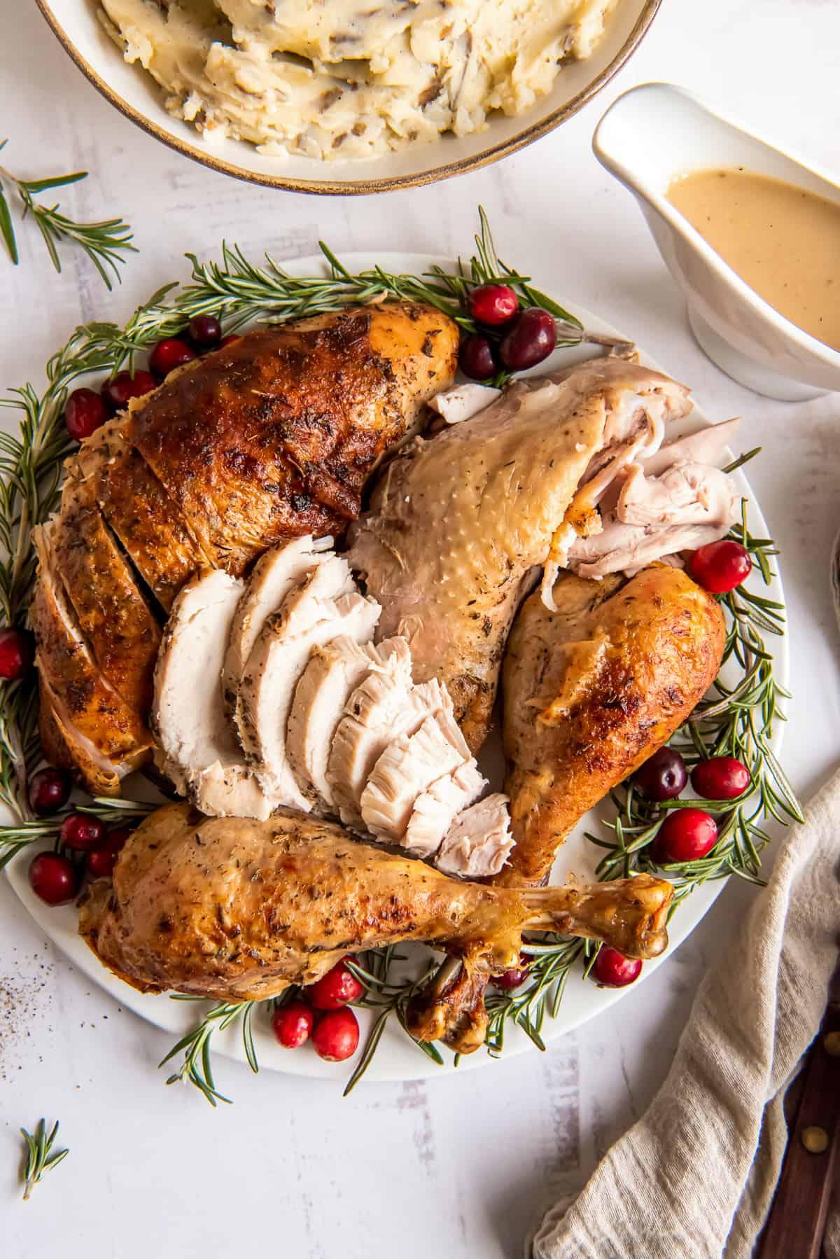 beautifully roasted turkey with fresh rosemary sprigs on a platter
