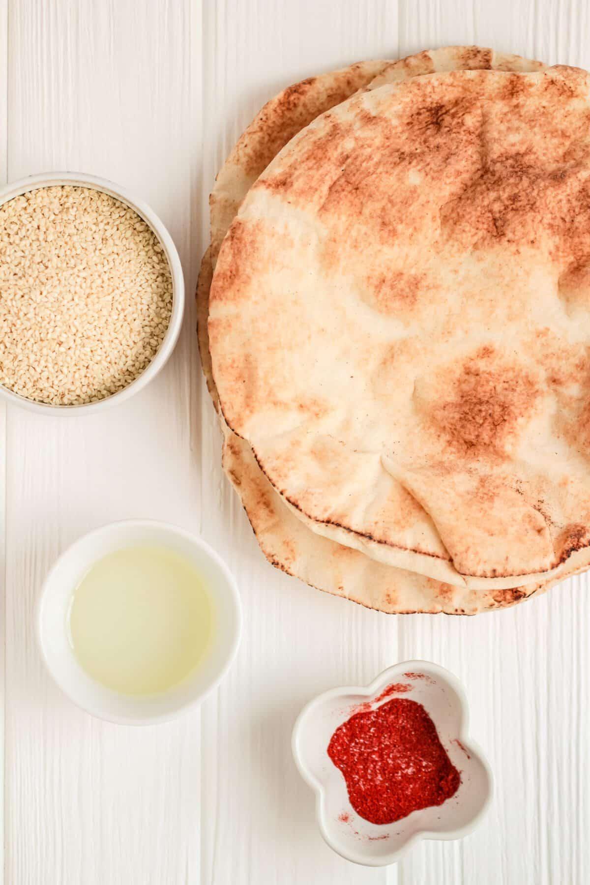Close-up shot of smoked paprika and sweet potato miso being spread on a pita bread