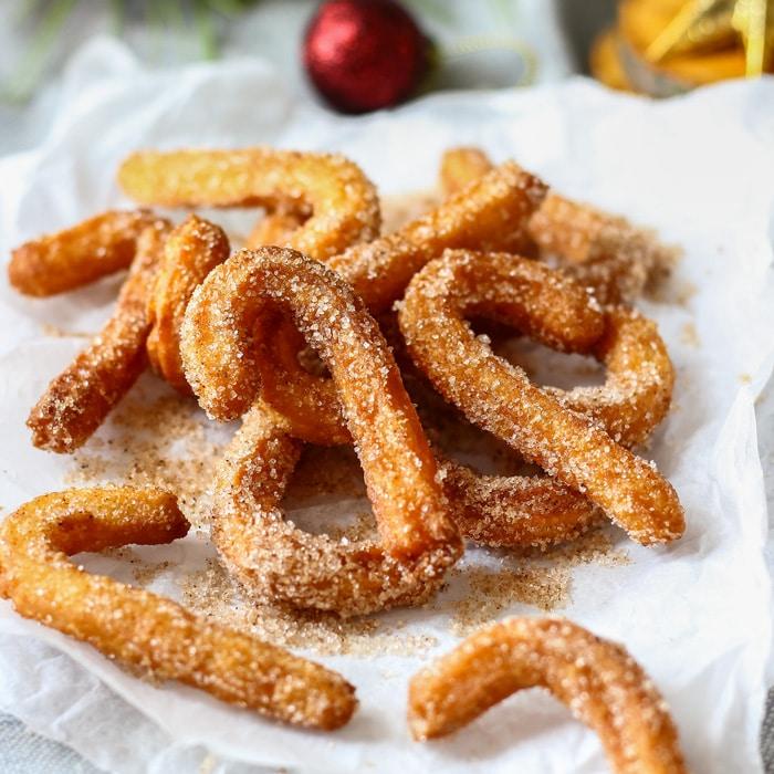 ingredients laid out for gingerbread cookie churros on a wooden surface