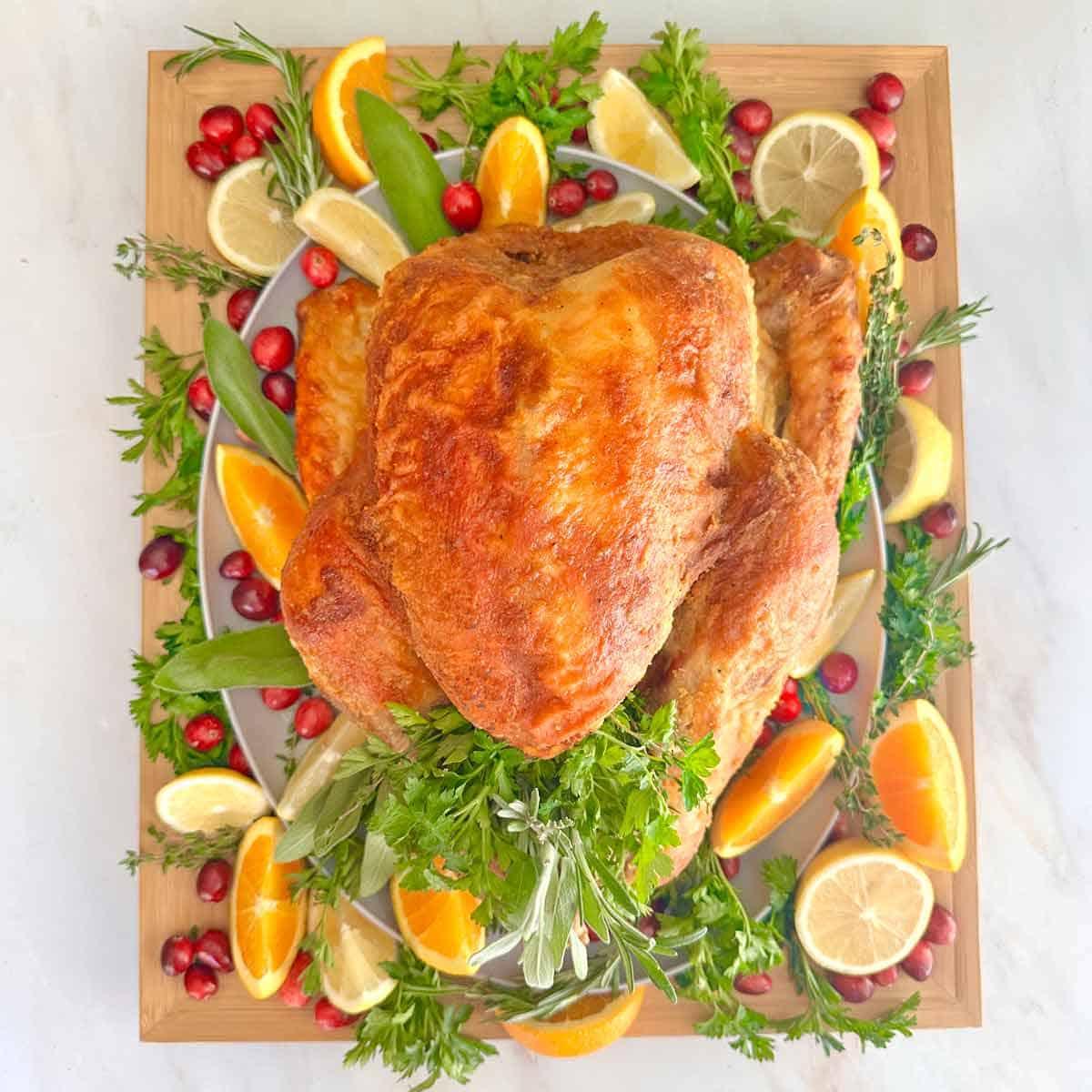 slices of roasted turkey breast and thigh meat on a platter, showing juiciness and crispy skin