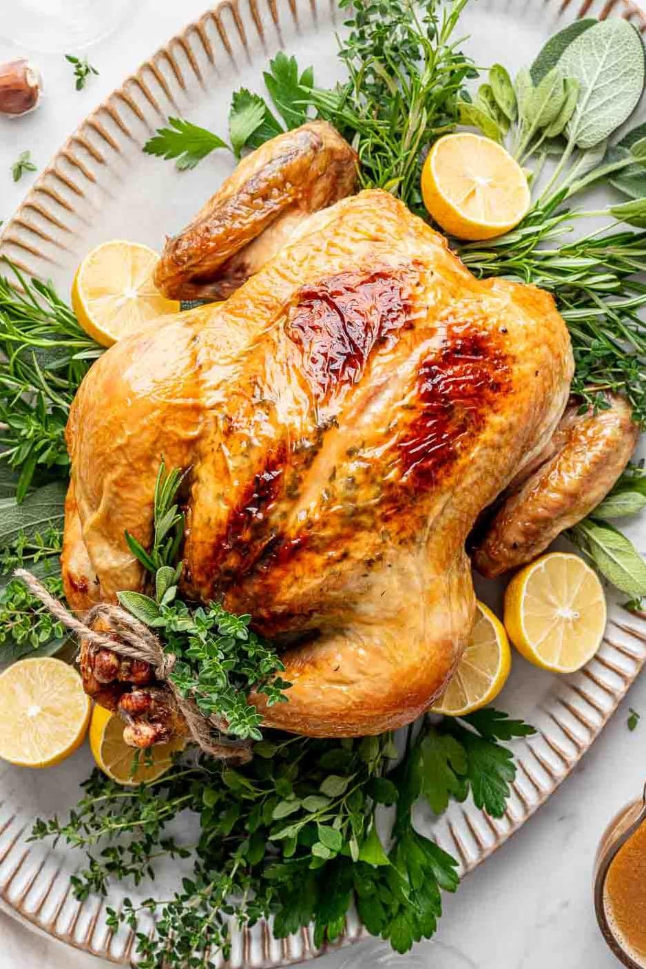 Roasted chicken with herbs on a platter