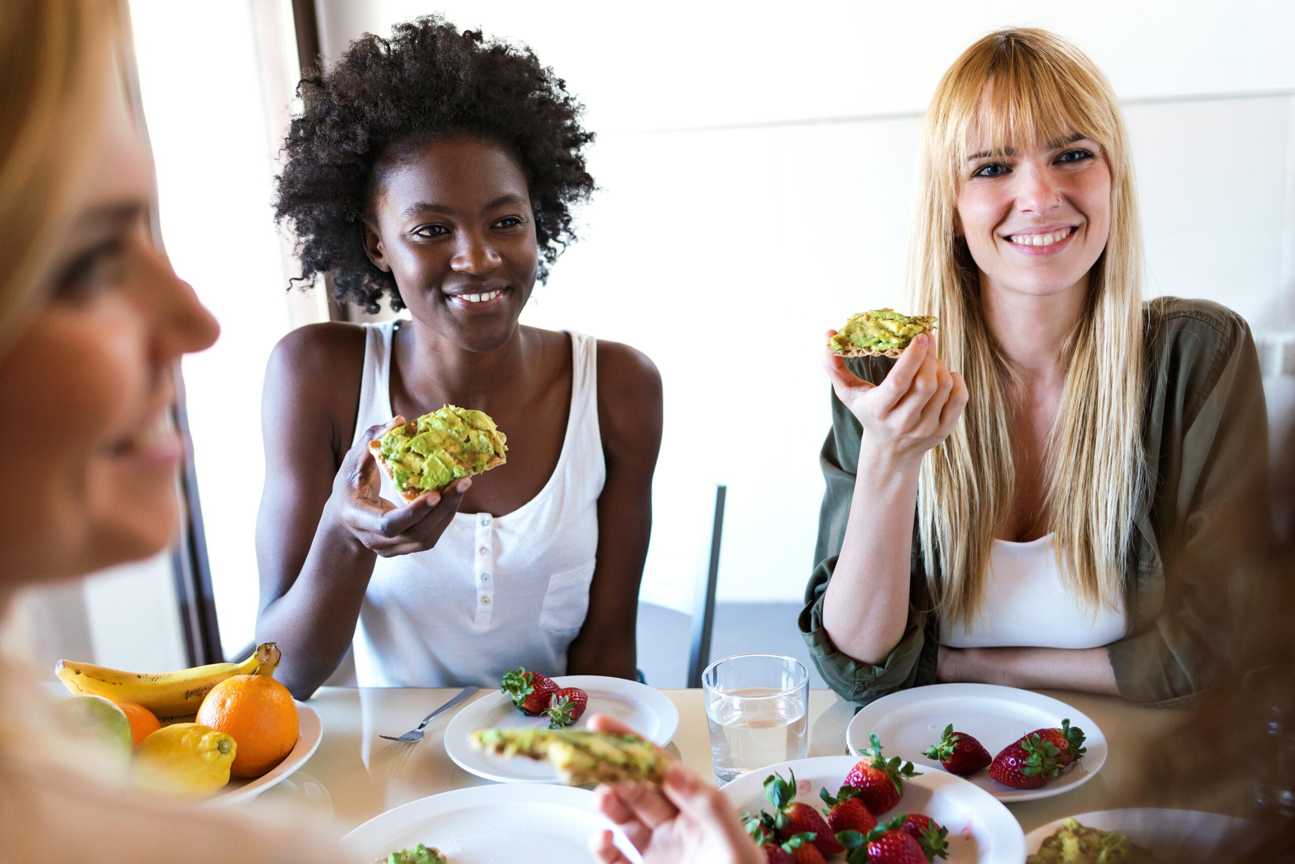 person enjoying avocado toast with a thoughtful expression