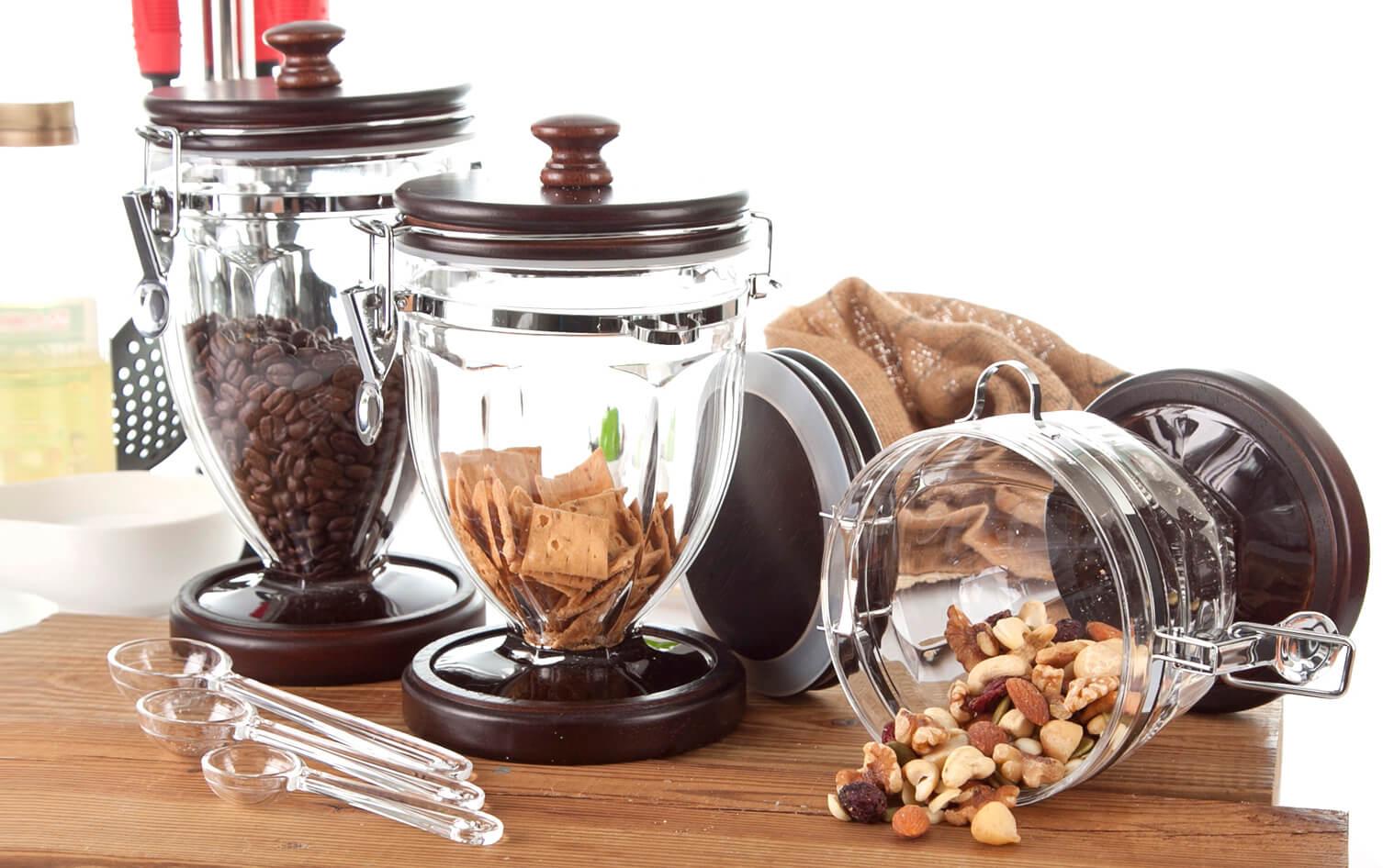 A collection of fresh produce, spices, and pantry staples neatly organized in various containers and shelves in a kitchen.