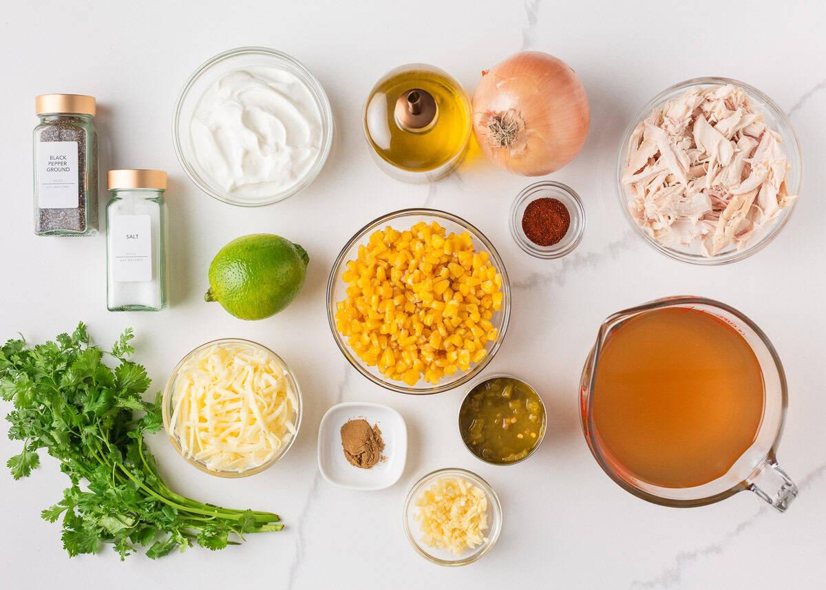 ingredients for Mexican street corn soup laid out on a wooden table