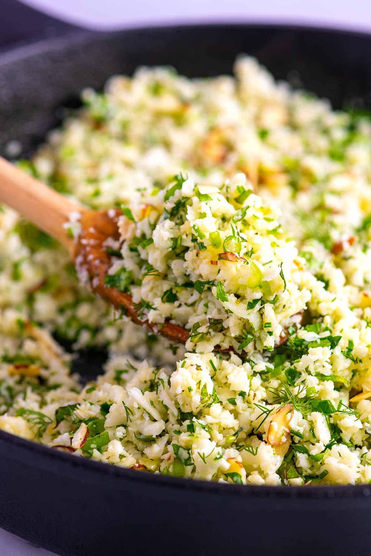 Close-up shot of the ingredients for the cauliflower rice with balsamic glaze, including fresh herbs.
